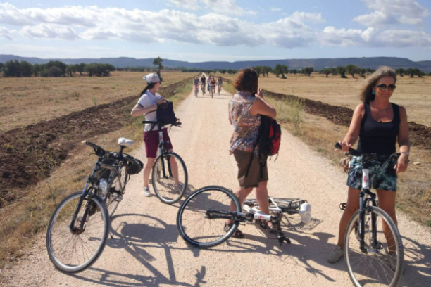 a group of people riding on the back of a bicycle