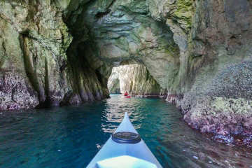 a cave next to a body of water