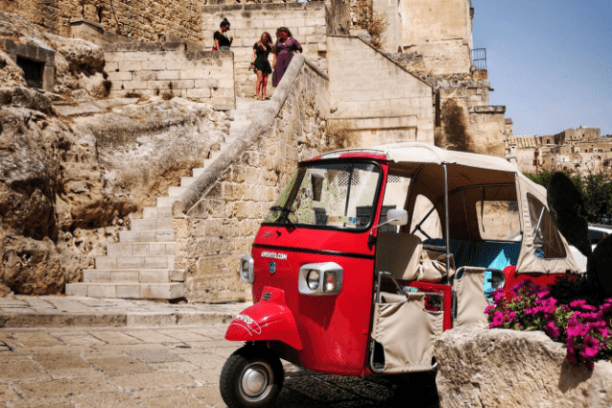 a car parked in front of a stone building