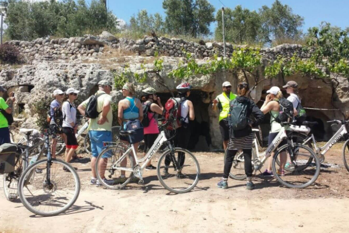 a group of people riding on the back of a bicycle