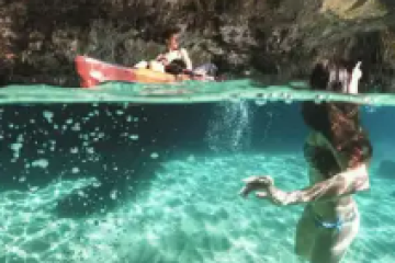 a girl riding a wave on a surfboard in the water