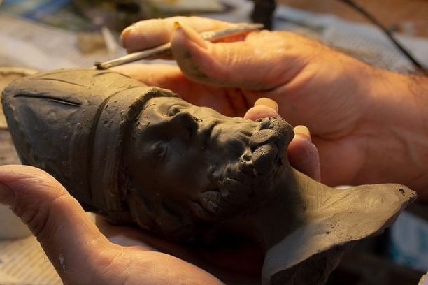 a hand holding an object in his hand