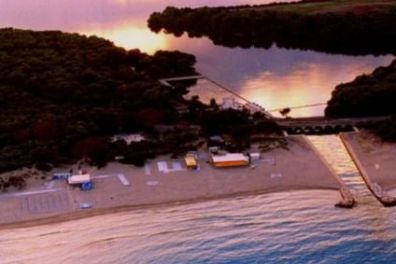a body of water with a mountain in the background