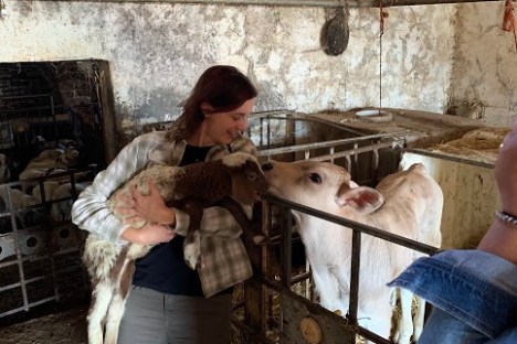a man and a woman standing next to a fence