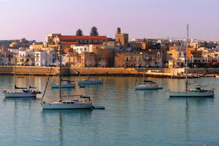 a small boat in a harbor next to a body of water