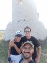 a man and a woman standing in front of a mountain in Puglia